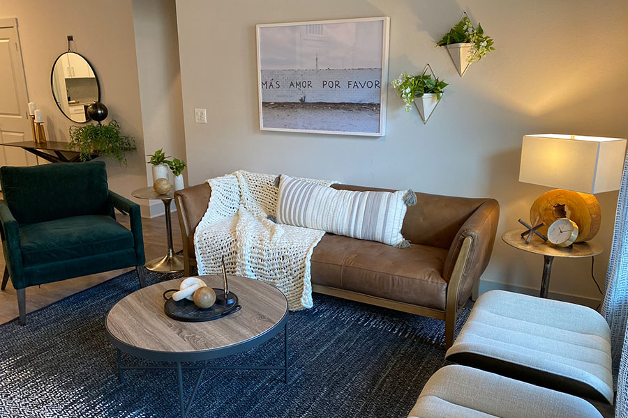 Create a unique space like this living room at Verge Apartments with apartment-friendly wall decor. Unique apartment wall decor in comfy living room
