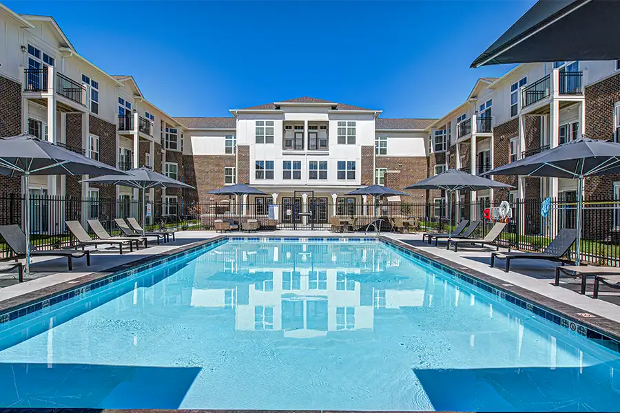 Pristine pool surrounded by apartment buildings at City Flats on Tenth Apartments.